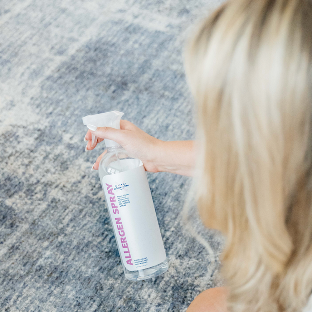 Dust Mite Allergy Treatments allergen spray being sprayed into a carpet by a women
