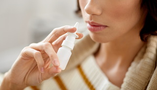 How to Properly Use Nasal Sprays women showing how to use a nasal spray