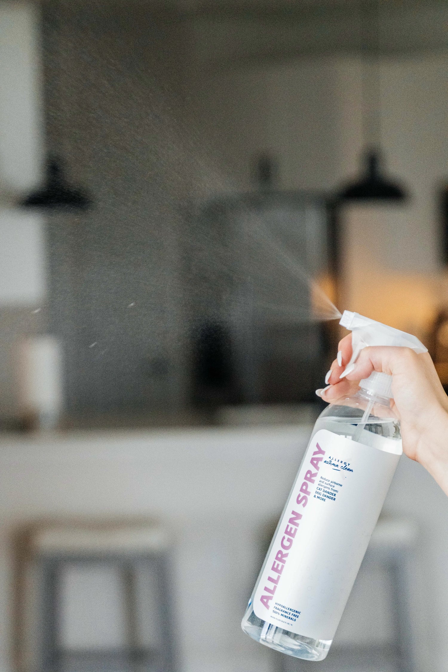 image of allergen spray bottle being sprayed in the air
