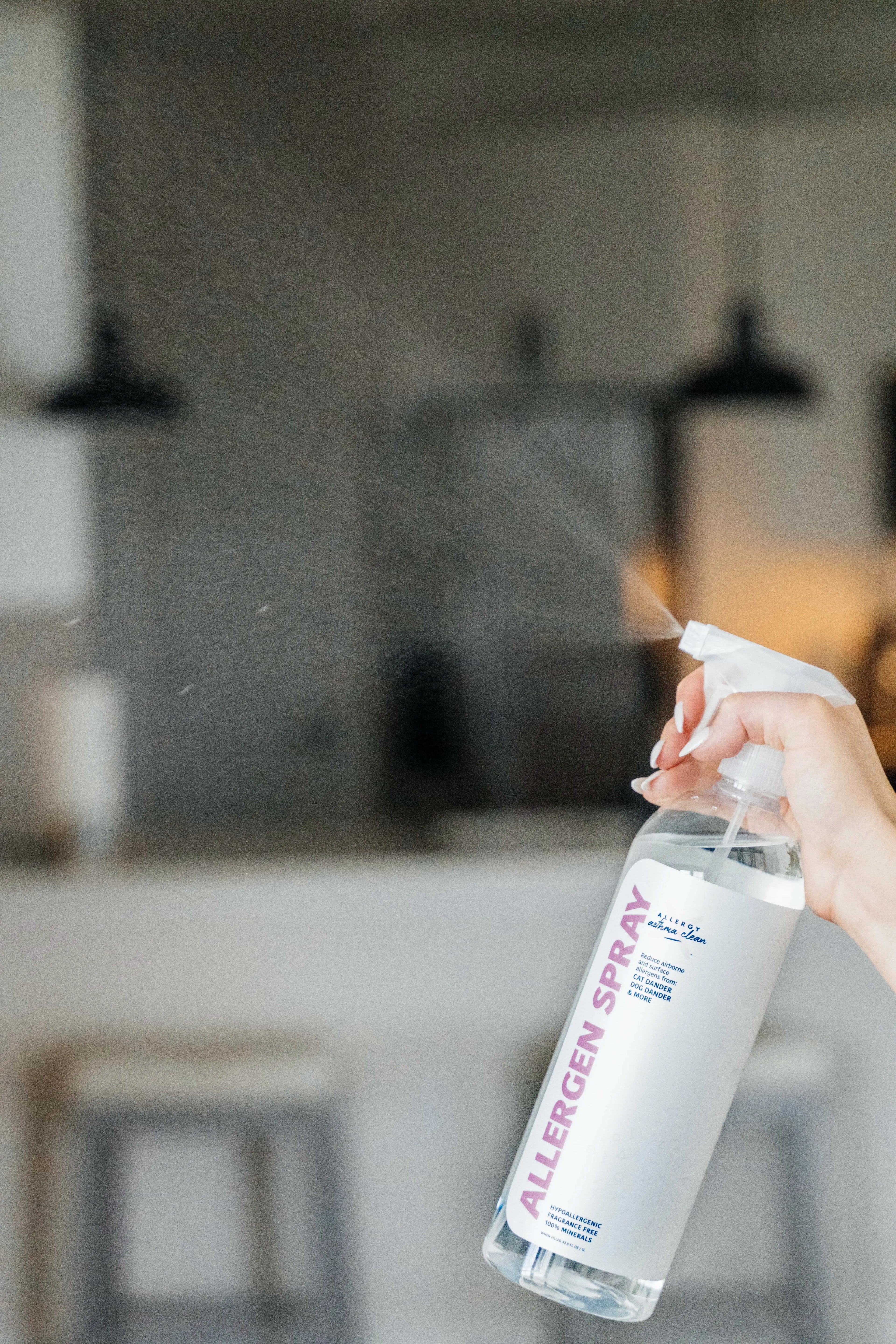 image of allergen spray bottle being sprayed in the air