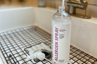 allergen spray 33.8oz bottle in the sink being filled with water