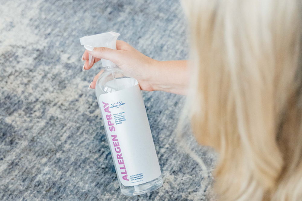 allergen spray being sprayed on a carpet