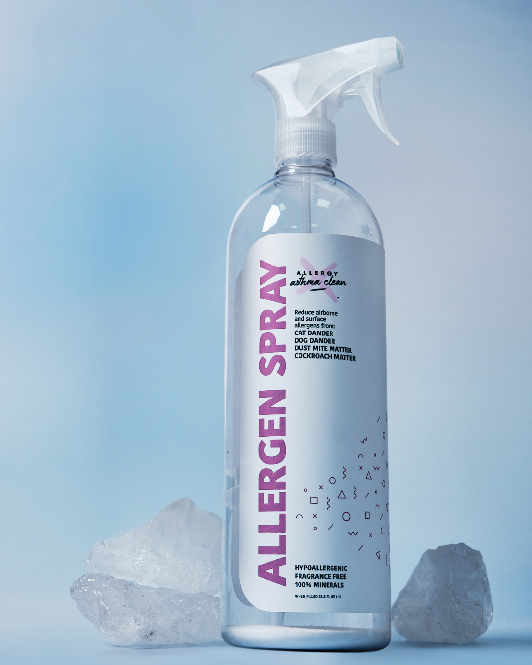 Allergen spray bottle with crystals on a light blue background