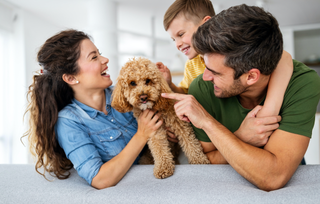 family with dog on couch